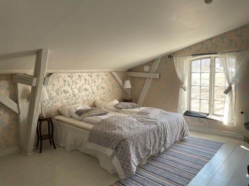 a bedroom with a bed and a window in it at Ravlunda Bränneri in Kivik