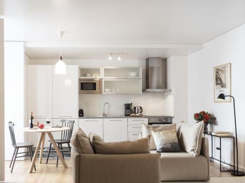 a living room and kitchen with a couch and a table at LSA Baixa Castelo by Numa in Lisbon