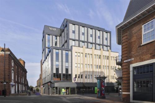 a tall building on a city street with buildings at Spark by Hilton London Romford in Romford