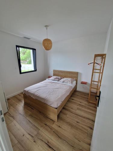 a bedroom with a bed and a ladder in it at Port de la paix in Biganos