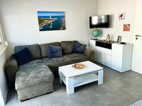 a living room with a couch and a table at Haus Seeblick Ferienhaus Priwall in Priwall