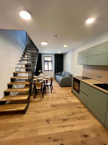 a kitchen and living room with a spiral staircase at Core Apartments Jihlava in Jihlava