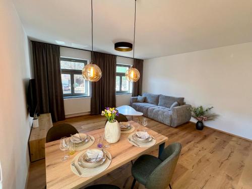 a living room with a table and a couch at Core Apartments Jihlava in Jihlava