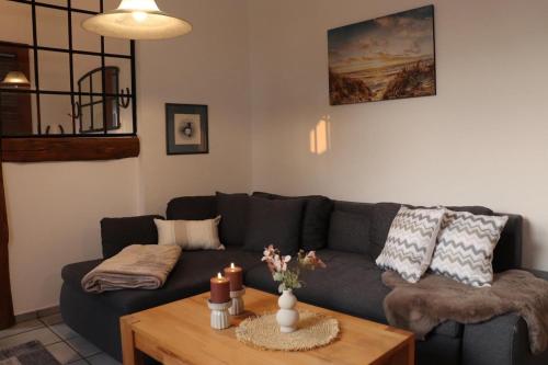 a living room with a couch and a coffee table at FeWo 2 - Haus Lorenzen in Hörsten