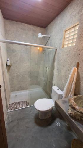 a bathroom with a shower and a toilet and a tub at Rancho Helena in Maceió