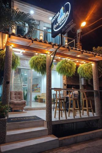 a bar with chairs and a sign on top of it at Hotel Panther Resort in Necoclí