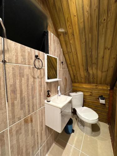 a bathroom with a toilet and a sink at A Cabana Caiçara in Ilhabela
