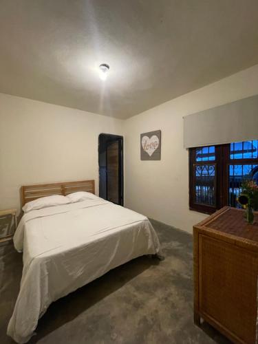 a bedroom with a large bed and a window at Arroyo Frío River Lodge in Arroyo Frío