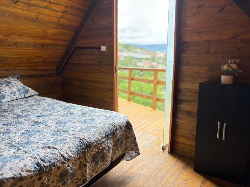 a bedroom with a bed and a balcony at A Cabana Caiçara in Ilhabela