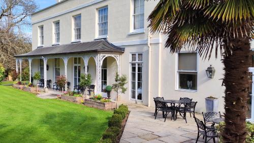 a house with a table and chairs in the yard at St Elizabeth's House in Plymouth