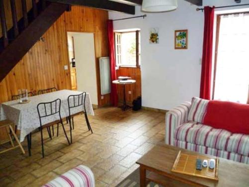 a living room with a table and a couch at KERMARIUs in Plougastel-Daoulas