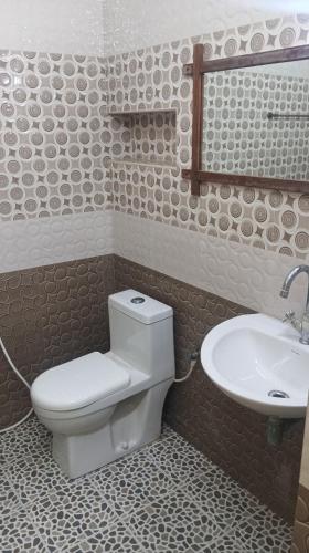 a bathroom with a toilet and a sink at Comfort Zone in Chennai