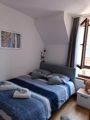 a bedroom with two beds with blue blankets at Divci Nova1- A8 in Divčibare