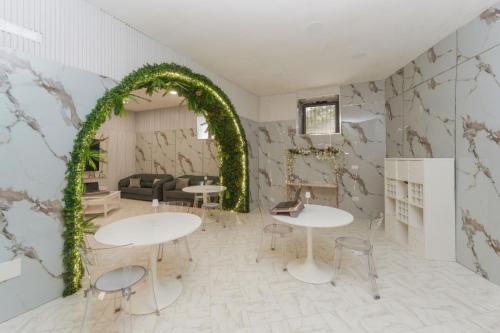 a room with two tables and an arch at Guest House Partenope in Naples