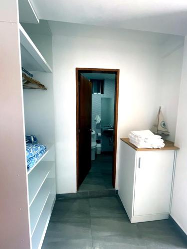 a hallway leading to a room with a bathroom at ALTEA HOTEL - San Bartolo in San Bartolo