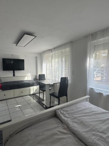 a room with a bed and a table and a bedroom at Gestüt Kaiserhof in Legelshurst