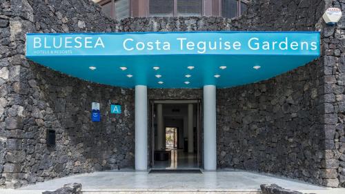 a building with a blue sign on it at BLUESEA Costa Teguise Gardens in Costa Teguise