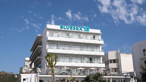 a white building with a sign on top of it at BLUESEA Anba Romaní in Cala Millor