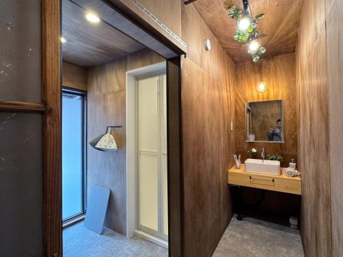 a bathroom with a sink and a mirror at SAUNA HOUSE Yutagawa in Tsuruoka