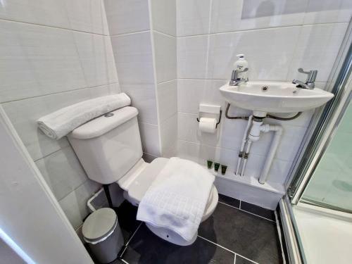 a small bathroom with a toilet and a sink at Incredible Private Rooms All with Private Bathrooms in a Fully Serviced House next to City Centre with Free Parking in Coventry