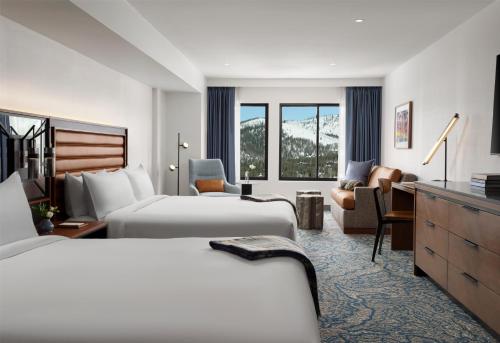 a hotel room with two beds and a desk at Hotel Alpenrock Breckenridge, Curio Collection by Hilton in Breckenridge