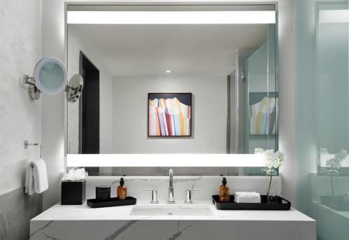 a bathroom with a sink and a mirror at Hotel Alpenrock Breckenridge, Curio Collection by Hilton in Breckenridge