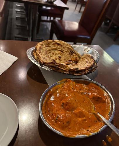 a table with two plates of food on a table at Sariyal Homestay in Kandikhal