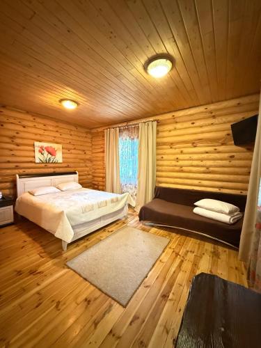 a bedroom with a bed in a wooden room at База отдыха Дубки in Orlovshchina