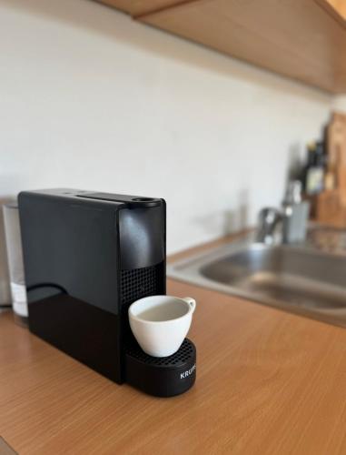a microwave sitting on top of a counter with a cup at Mirca by the Sea in Mirce