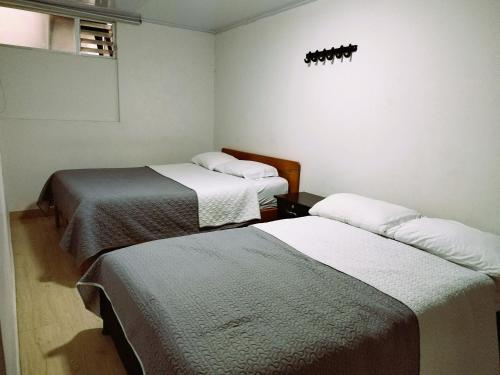a room with two beds in a room at Bohemia Hotel in Tunja