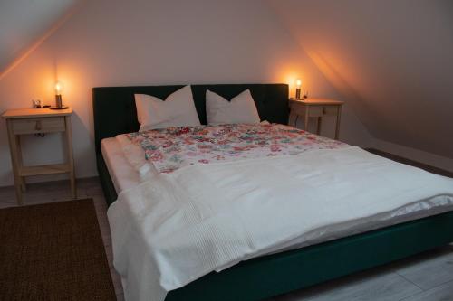 a bedroom with a large bed with two night stands at Agroturystyka „Między Polami” in Zalewo