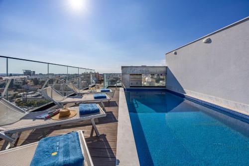 a swimming pool on the roof of a building at Piliou Premium Apartments in Limassol