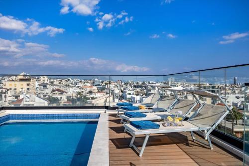 a balcony with chairs and a swimming pool at Piliou Premium Apartments in Limassol
