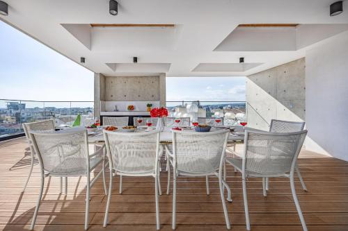 a kitchen and dining room with a table and chairs at Piliou Premium Apartments in Limassol
