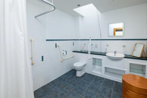 a white bathroom with a toilet and a sink at 2 Bed in Reef oc-r30133 in Uig