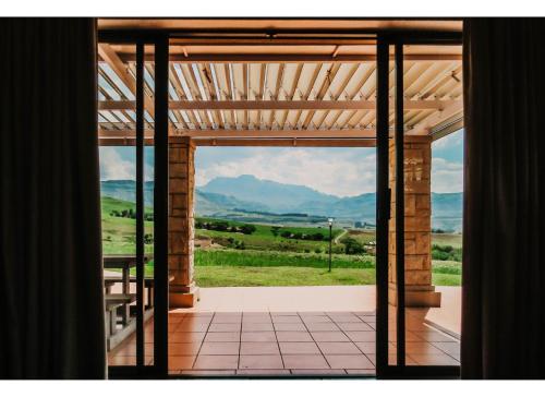 an open door to a patio with a view at Aloe Corner, Cathkin Estates by Euphoric Leisure in Ardmore
