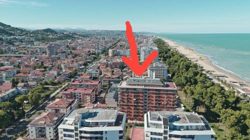 an aerial view of a beach with a red arrow at Park & Seafront Pescara in Montesilvano