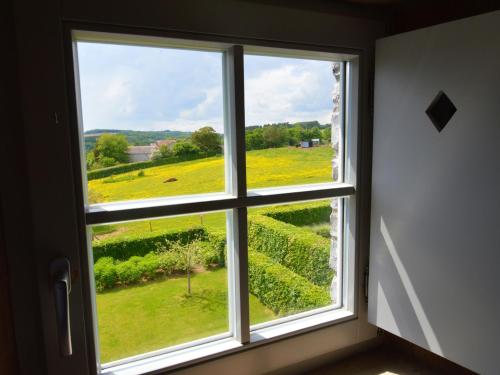 a window with a view of a field of flowers at Luxurious Farmhouse in Falaen with Sauna in Maredsous