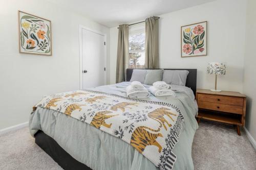 a bedroom with a bed with towels on it at Hidden Gem Lake House 3BR, 2.5BA in Holbrook