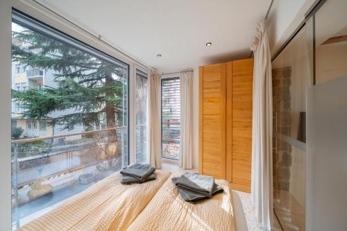 a room with a large window with two pillows at Gardar in Bolzano