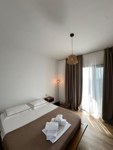 a bedroom with a bed with towels on it at Ambelas Getaways in Himare