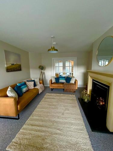 a living room with a couch and a fireplace at North Coast Nook in Portrush