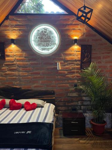 a bedroom with a bed in a brick wall at Killa Glamping in Sangolquí