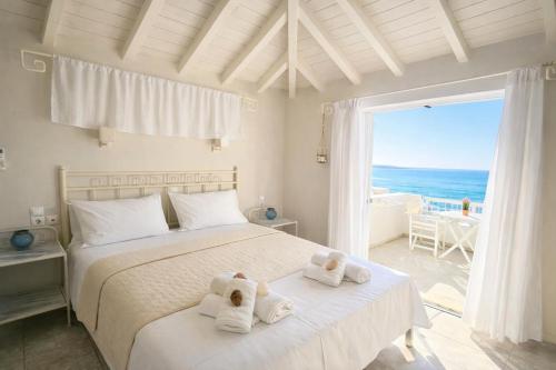 a bedroom with a bed with towels on it at Ammos Boutique Rooms-Seafront Stay in Elafonisos in Elafonisos