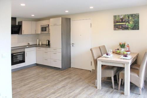 a kitchen and dining room with a table and chairs at Quartier Spreestraße - App 2 in Burg