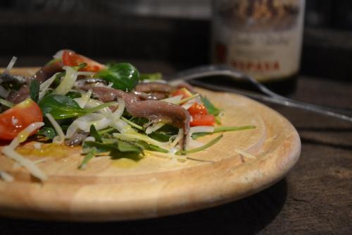 a plate of food on a wooden cutting board at Gec in Zaprešić