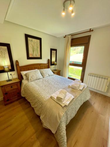 a bedroom with a bed with two towels on it at Can Rios-Felechosa - Aller in Felechosa
