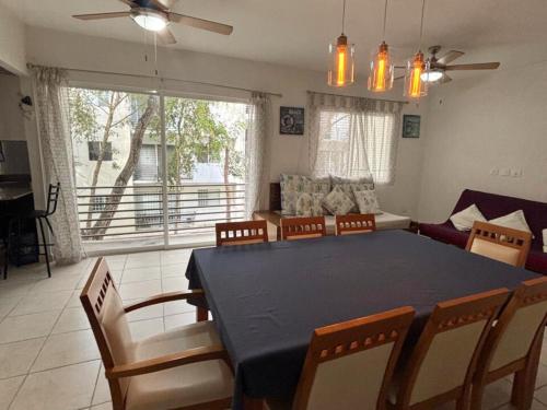 a living room with a blue table and chairs at NEFELI departamento by Xenia Caribe in Playa del Carmen