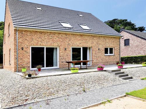 a brick house with a bench in front of it at Modern Holiday Home in Hastiere near Forest in Hastière-par-delà