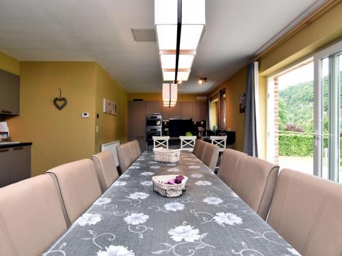 a dining room with a long table and chairs at Modern Holiday Home in Hastiere near Forest in Hastière-par-delà